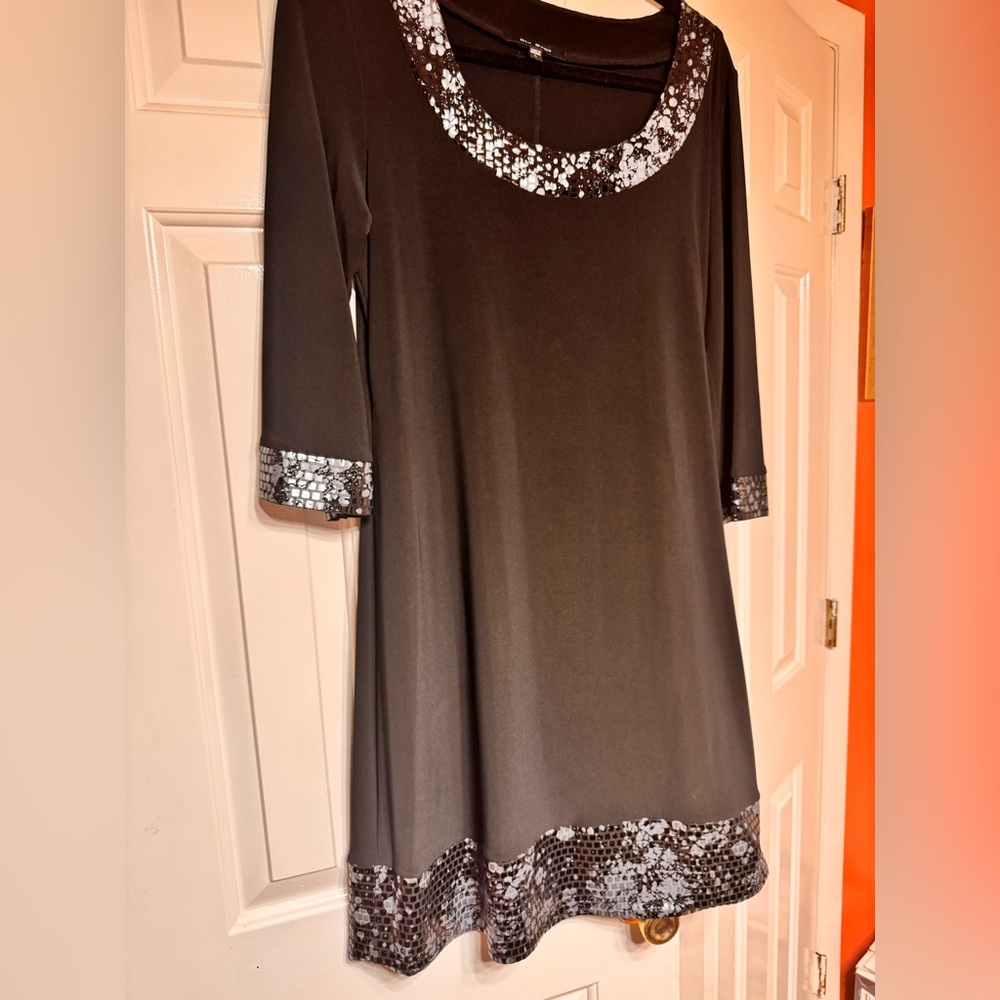 Black dress with embellished neckline, sleeves and bottom of dress.